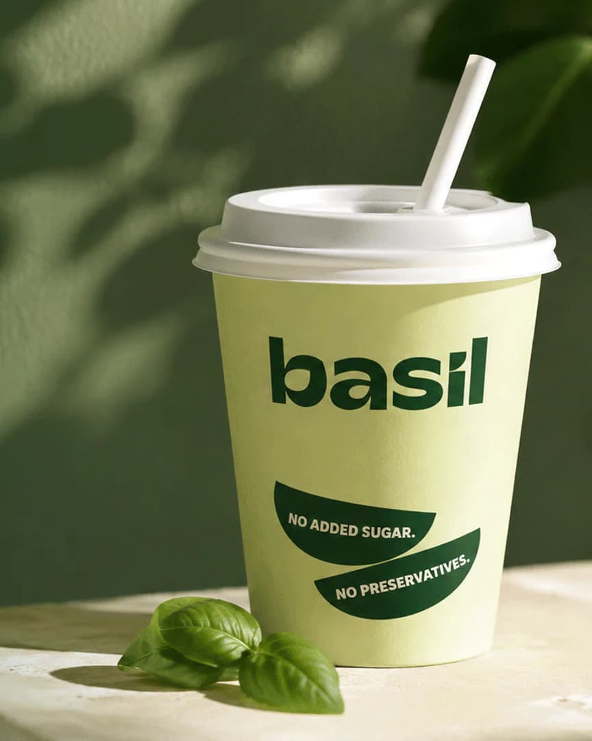 Basil cup on a green photographic background — Made fresh. Every time.
