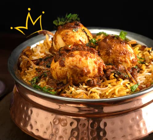 Detail of the Royal Biryani House campaign: a hammered-copper handi of biryani